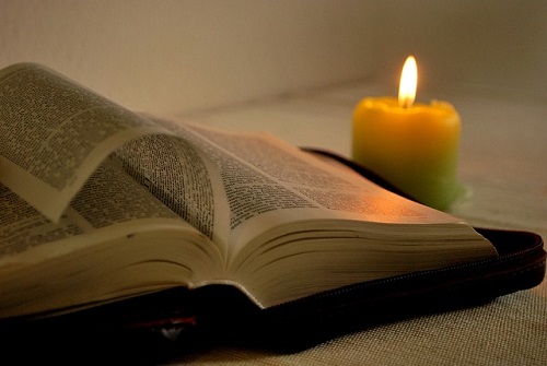 candle and open Bible