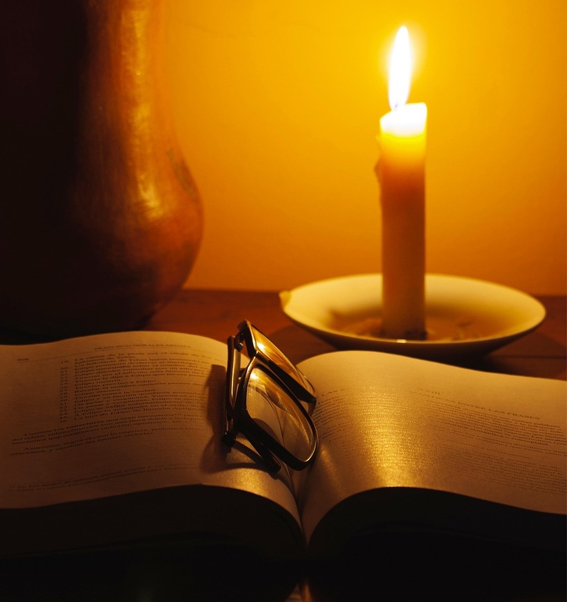 candle-6942931_1280 glowing candle with book and glasses